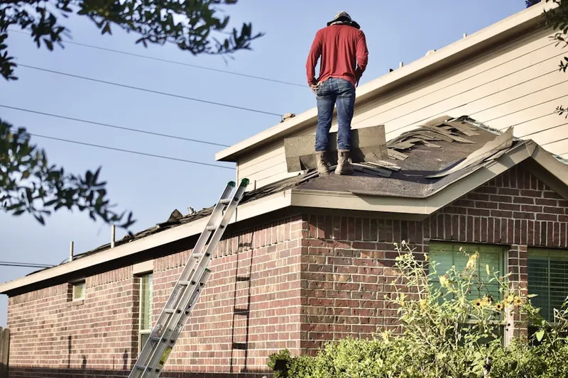 Professional roofer working on a residential roof in Knowlton